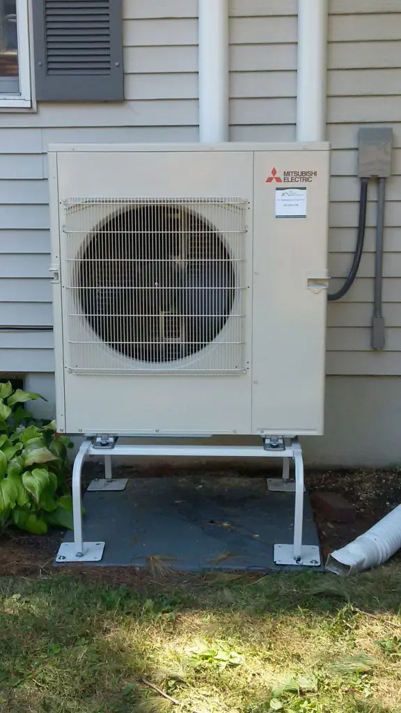 A professionally installed Mitsubishi heat pump outside of a home in Gorham Maine