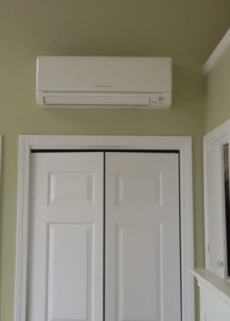 an indoor heat pump unit over a folding closet door